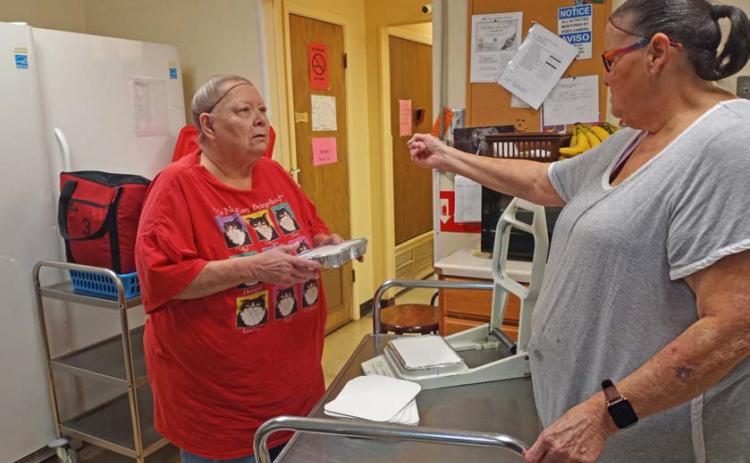Lampasas Senior Center cook Theresa Waechter, left, and volunteer Marsha Schaffer work to prepare the day’s meals before they go out to those who participate in the program for homebound seniors. courtesy photo | Lampasas Senior Center