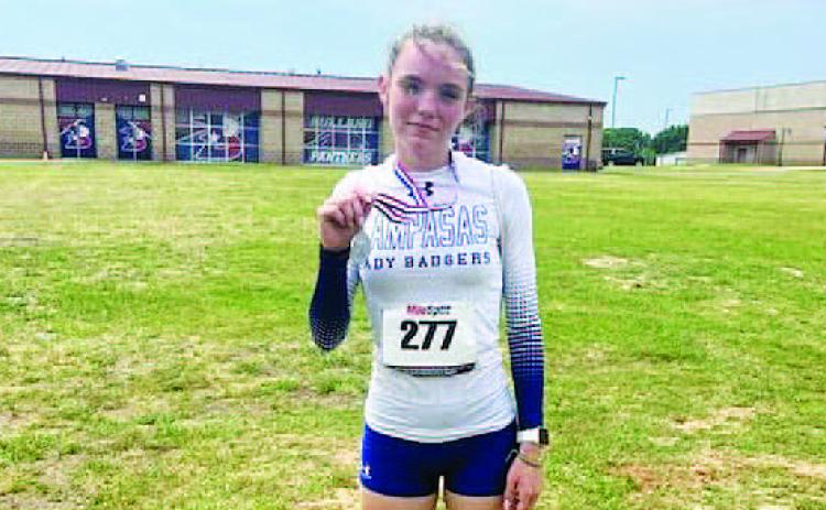 COURTESY PHOTO | LAMPASAS ATHLETICS FACEBOOK Teagan Reiss poses with her second-place medal from the regional track meet last week.