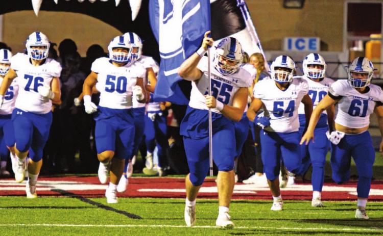 Conner Keele leads the Badgers onto the field in their final regular-season game of 2021 against Fredericksburg. FILE PHOTO