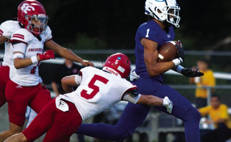 HUNTER KING | DISPATCH RECORD Ty Johnson runs away from Fredericksburg defenders for a touchdown in the first quarter.