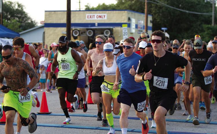10K runners take off from the starting line at last Saturday’s event.