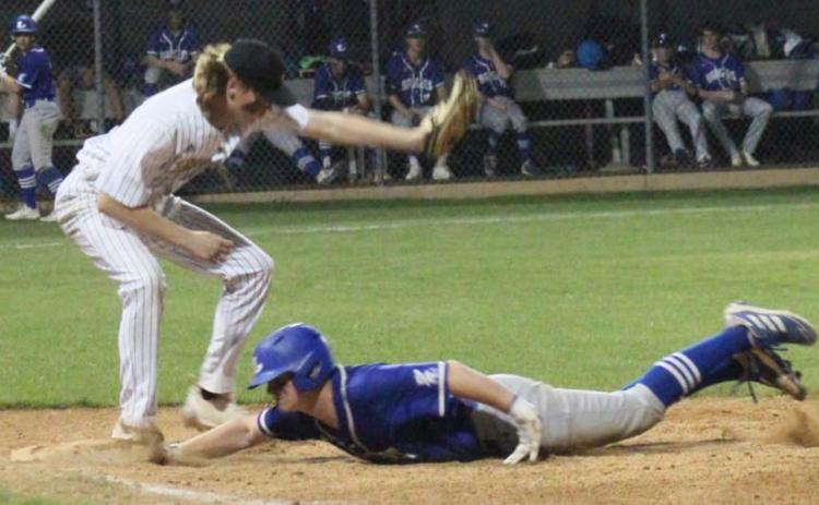 Gauge Gholson slides into first base in a previous district game. Gholson reached base twice against Stephenville, the district leader, on Tuesday. CHRIS YBARRA | DISPATCH RECORD