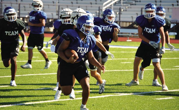 HUNTER KING | DISPATCH RECORD Dailin Fagan looks up field for defenders during a practice last week. He will take his varsity carry tonight in Elgin.