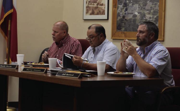 Trustees, from left to right, Randy Morris, Harvey Stinnett and Jeff Rutland enjoy meals prepared by Lampasas High School culinary arts students before Monday’s school board meeting. ERICK MITCHELL | DISPATCH RECORD
