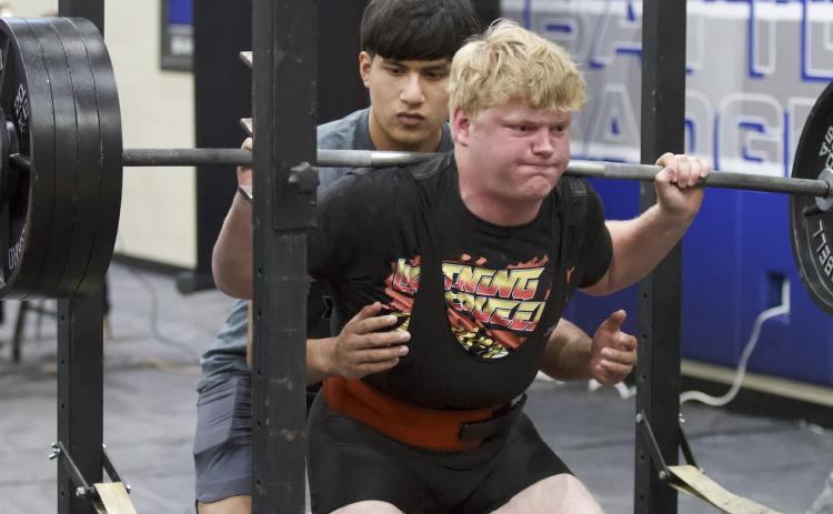 Brody Hilgenberg pushes up weight during the squat portion of the Badgers’ home powerlifting meet on Thursday. HUNTER KING | DISPATCH RECORD