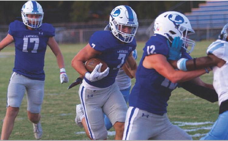 HUNTER KING | DISPATCH RECORD Jett Walker follows the block of Bryson Roberts in the first quarter of last Friday’s win.