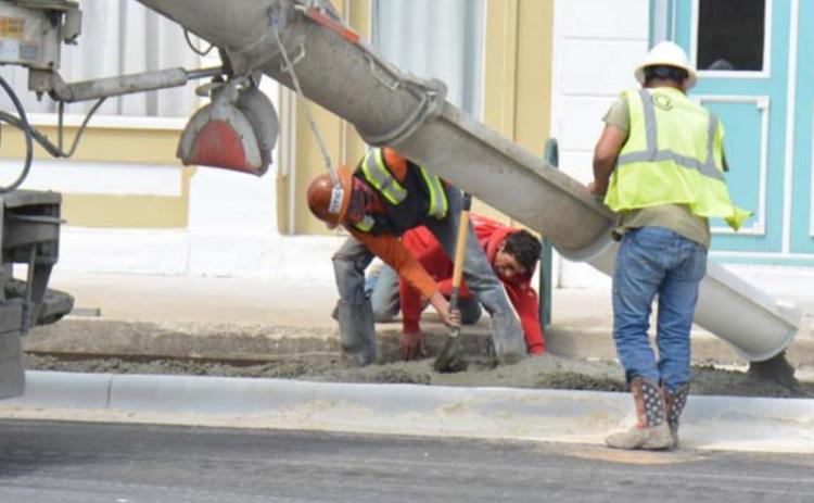 Work crews place cement for the Third Street sidewalks last week. Drivers can now drive on the street, but the project is not entirely completed as of Thursday morning. MONIQUE BRAND | DISPATCH RECORD