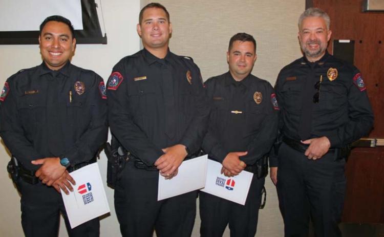 Lampasas Police Chief Jody Cummings (far right) congratulates new cadets, from left to right, John Reza, Jameson Varnado and Brandon English at the Central Texas College Police Academy graduation ceremony. courtesy photo