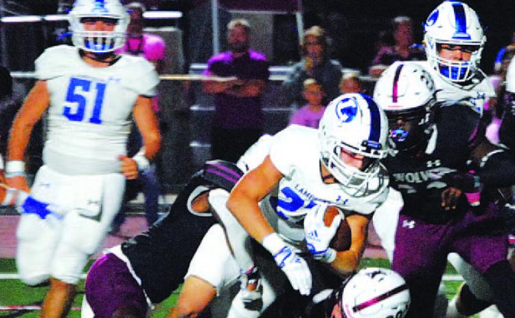 Jett Walker falls forward for extra yards on a run against Davenport last Friday. HUNTER KING | DISPATCH RECORD