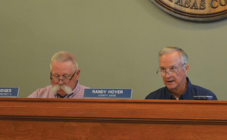 At left, Precinct 3 Commissioner Lewis Bridges looks on as County Judge Randy Hoyer speaks during the court’s regular meeting Aug. 12. erick mitchell | dispatch dispatch