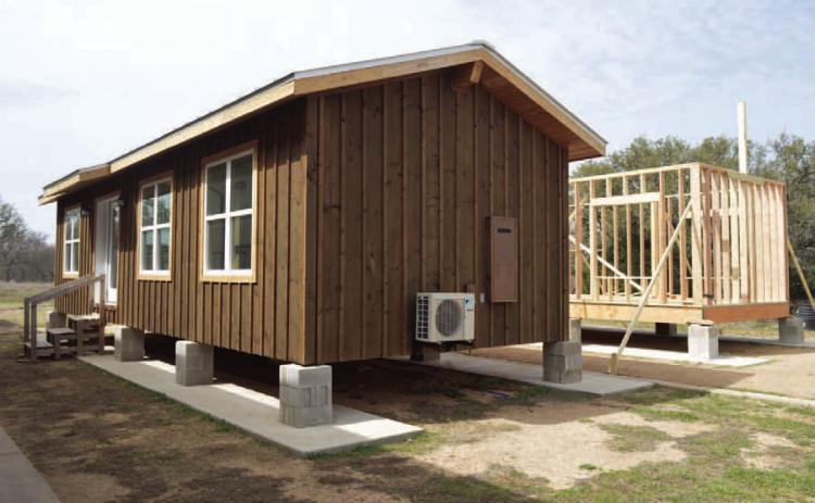 ERICK MITCHELL | DISPATCH RECORD Students in the high school’s construction program have worked with Creating Badger Builders mentors to complete a 560-square-foot tiny home. A second tiny home project, shown at back right, is in the intial construction stages.