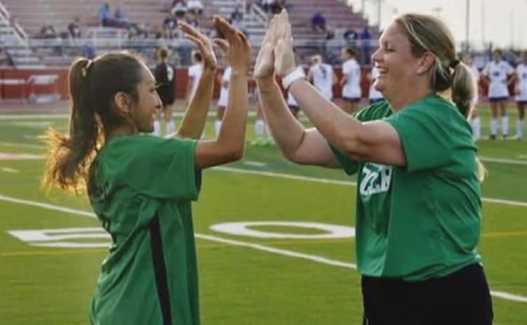 Burnside high-fives a former player with the Lady Bulldogs. COURTESY PHOTO