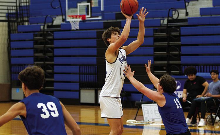 HUNTER KING | DISPATCH RECORD Calum Mitchell shoots a three-point shot during a recent practice. Basketball season is officially underway.