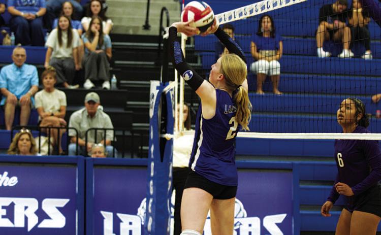 Ellie Felkner sets the ball up for a spike during the match against Florence. HUNTER KING | DISPATCH RECORD