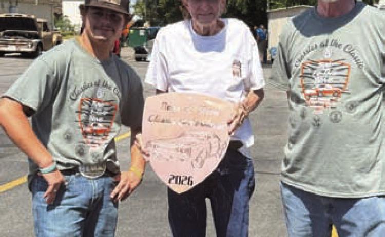 James Kincheloe, center, shows off the plaque he received at the annual Classics at the Classic Car Show. The show for next year is planned for Sept. 11, 2027. COURTESY PHOTO