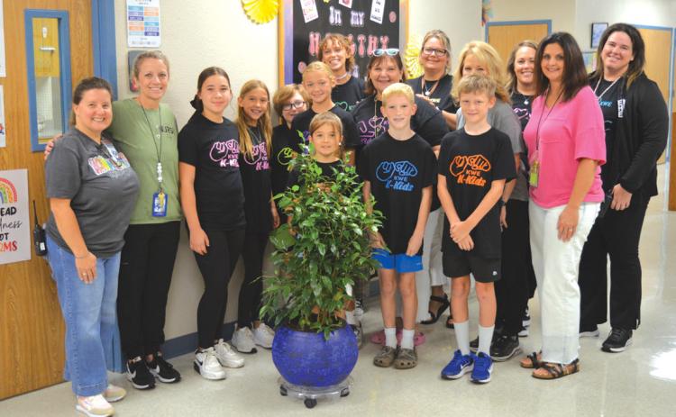 erick mitchell | dispatch record Fifth-grade Kline Whitis Elementary School students presented a tree last week to Hanna Springs Elementary in remembrance of former school nurse Tobi King.
