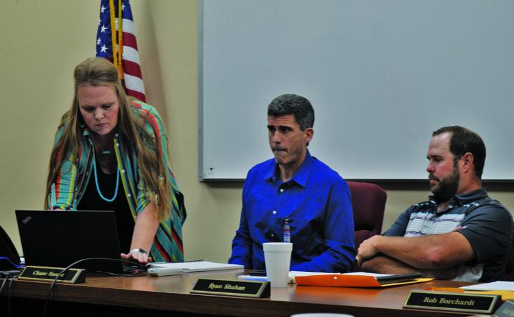 Liz Haviland, director of the Lampasas ISD’s Career and Technical Education program, works at her laptop to start a PowerPoint presentation for the school board meeting on Monday. Next to her are Superintendent Dr. Chane Rascoe, center, and Ryan Shahan, president of the LISD Board of Trustees. Enrollment in CTE classes continues to grow, Haviland said. ERICK MITCHELL | DISPATCH RECORD
