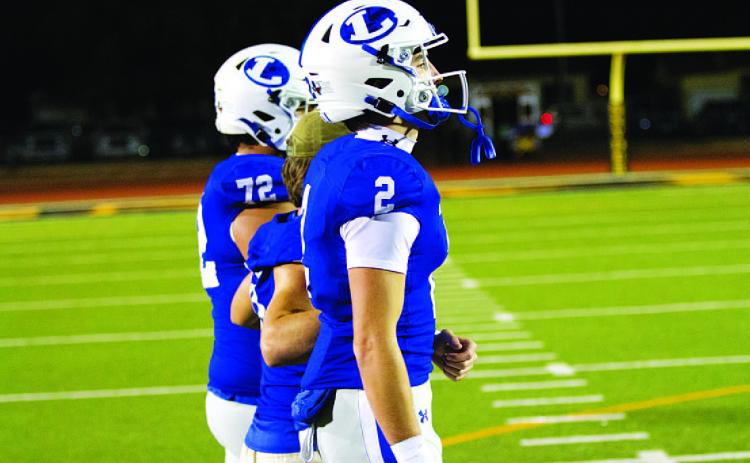 HUNTER KING | DISPATCH RECORD Bryson Roberts and his fellow captains head out for the coin toss last Friday.