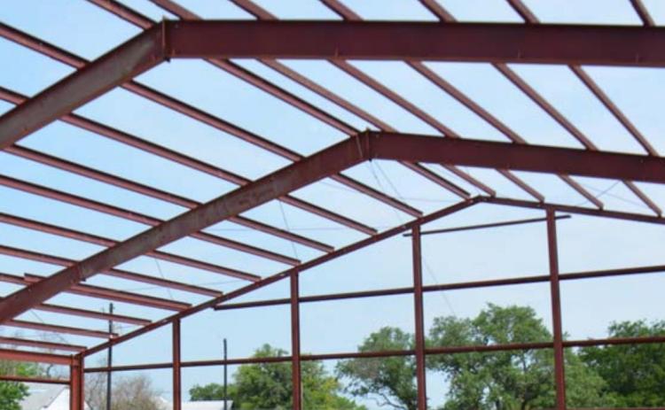 Red steel trusses for the 10,000-square-foot building that will become the new Lampasas Community Church can be seen at its location on East Fourth Street. Monique brand | dispatch record