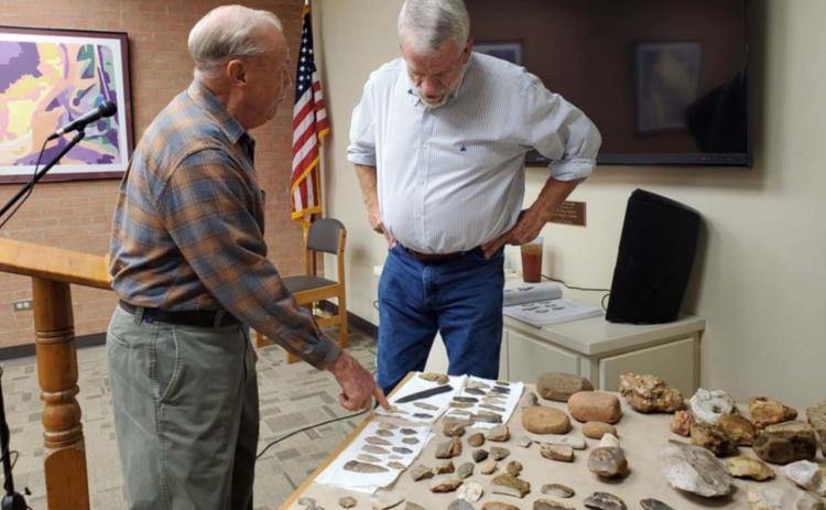 Former mayor Jack Calvert, left, and Lampasas County Historical Commission member Boyce Cabaniss talk about artifacts Cabaniss has unearthed across the area. The historian offered a special presentation last week at the library. LENORA ISENHOUR | COURTESY PHOTO