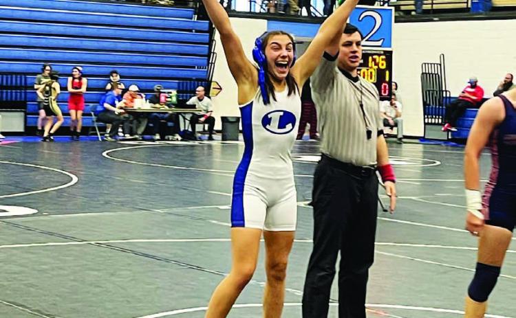 COURTESY PHOTO | LHS WRESTLING TWITTER Charlie Freese celebrates her match win at the district competition last week.