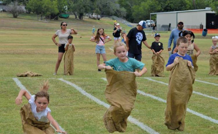 Children try their best to maintain balance during sack races at Kids’ Day Activities hosted by the Lampasas Boys and Girls Club. ERICK MITCHELL | DISPATCH RECORD