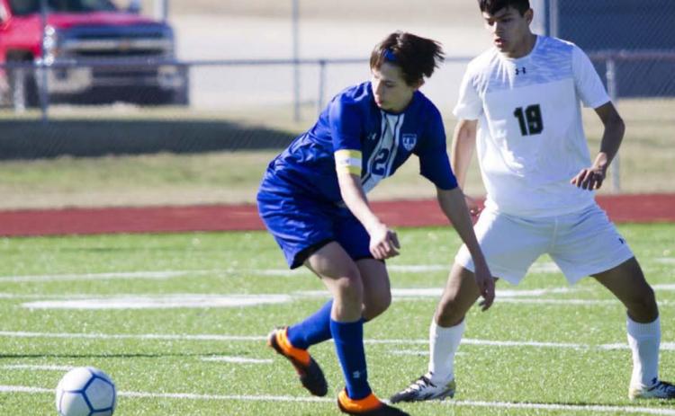 Senior striker Cody Woods (2) races a Canyon Lake Hawk to the ball on Saturday. JEFF LOWE | DISPATCH RECORD