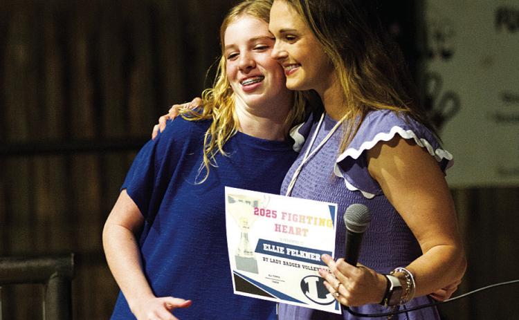 HUNTER KING | DISPATCH RECORD Ellie Felkner hugs Ali Tippie as she receives the Fighting Heart Award.