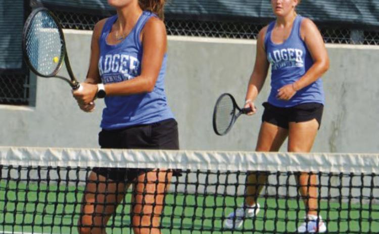 Caroline White, front, and Sydney Unger await a serve during their doubles match against Leander last week. COURTESY PHOTO | KENNETH PEISER
