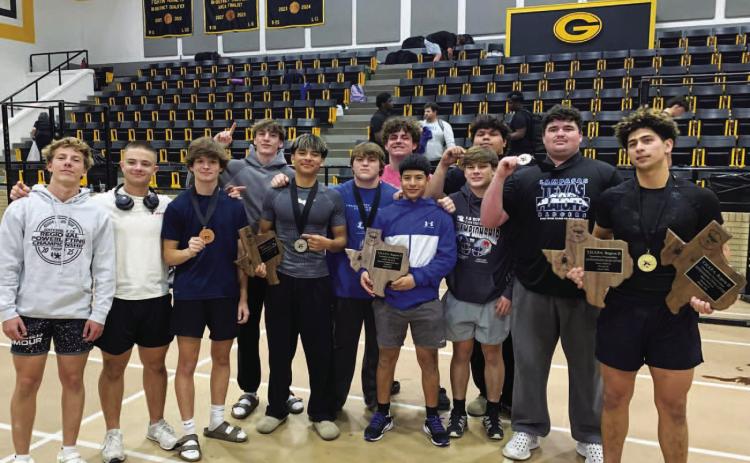 COURTESY PHOTO | LAMPASAS ATHLETICS FACEBOOK The boys’ powerlifting team shows off their plaques and medals from the regional meet last week.