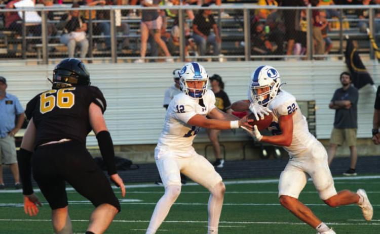 Ross Kothmann makes a handoff to John Stenson against Gatesville. ANA SOFIA MEYER | DISPATCH RECORD