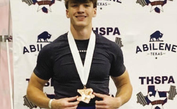 Aaron Everts shows off his medal for fifth place at the state powerlifting meet last weekend. COURTESY PHOTO