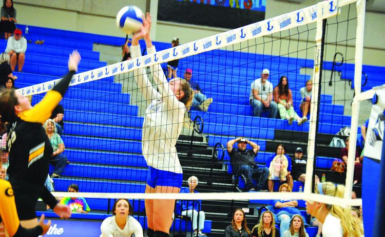 Breana Pelbath goes up and makes a block. She has led the team in blocks and kills all season. HUNTER KING | DISPATCH RECORD