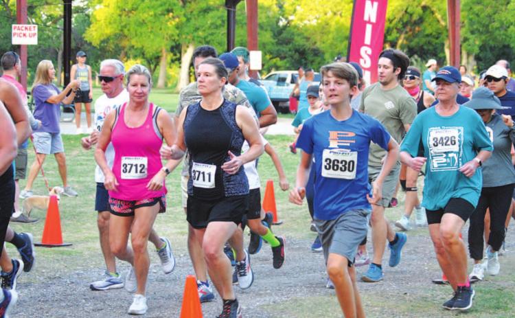 Runners start their race from Hancock Park Pavilion on Saturday. HUNTER KING | DISPATCH RECORD