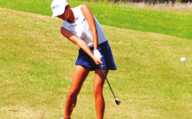 Shaylee Wolfe makes contact with a pitch shot during the state golf tournament on Tuesday. HUNTER KING | DISPATCH RECORD