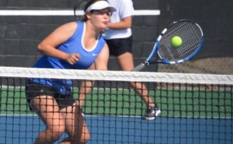 Kelsea Moyer hits the ball near the net while her doubles partner Abriana Flores plays the baseline. KENNETH PEISER | COURTESY PHOTO