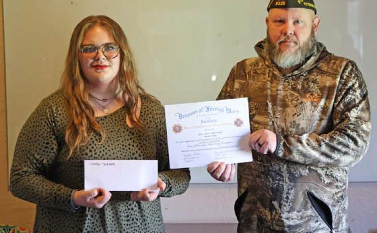 joycesarah mccabe | dispatch record Mandy Jordan, a 10th- grader at Learning Steady Academy, accepts a scholarship award from Lampasas VFW Commander Chris Adolph. Jordan had the winning audio essay answering the question, “What are the greatest attributes of our democracy?”
