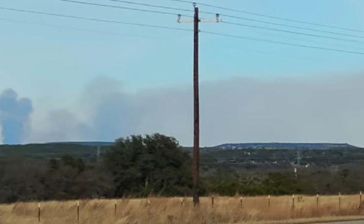 Smoke is seen on the horizon last week in rural Lampasas County. DISPATCH RECORD PHOTO