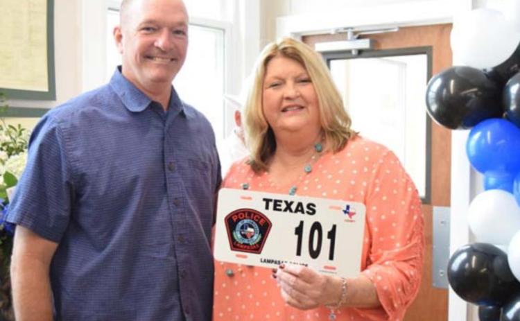 Texas DPS Patrol Sgt. Ryan McKittrick presents Sammy Bailey with a novelty Highway Patrol plate in honor of her retirement. ALEXANDRIA RANDOLPH | DISPATCH RECORD