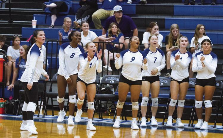 The Lady Badger volleyball bench was on their feet to help push teammates over the line to victory during Tuesday’s opening game against Manor New Tech. ERICK MITCHELL | DISPATCH RECORD