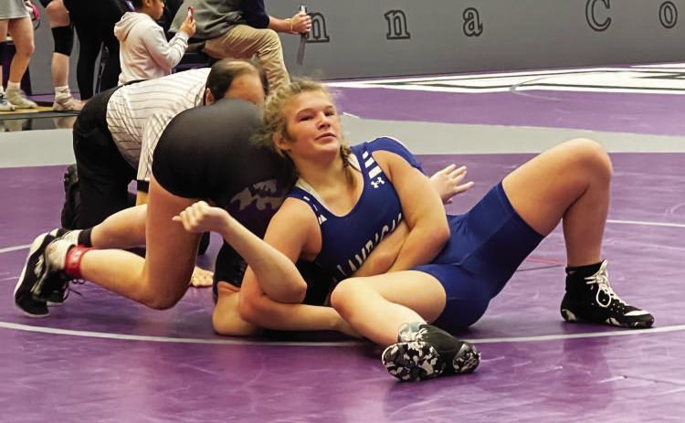 Taylor Martell attempts to pin her opponent during a match at the regional wrestling meet in Anna last weekend. COURTESY PHOTO | LAMPASAS WRESTLING