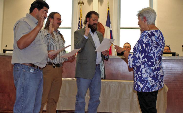 Outgoing Mayor TJ Monroe administers the oath of office to newly elected Lampasas City Council members, from left, Eric Hernandez, Zachary Morris and Charles Pratus. Hernandez and Pratus are serving their first terms, while Morris was re-elected May 6 for a new term on the council. COURTESY PHOTO