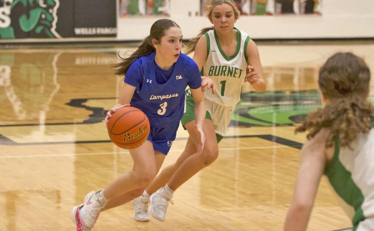 Kase Bumpus dribbles past a Burnet defender during the Lady Badgers’ district victory on Friday. HUNTER KING | DISPATCH RECORD