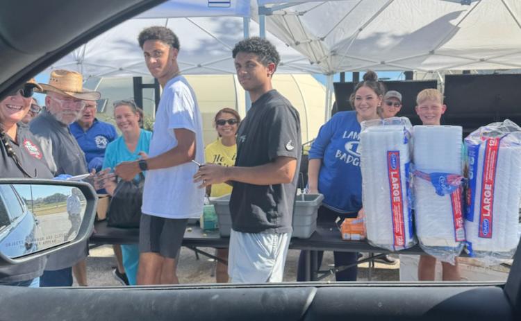 Volunteers were on hand Aug. 13 outside Grace Fellowship for a drive-through pork chop dinner fundraiser to benefit Building Badgers Youth League. Benny Boyd provided all the food so proceeds could be used for the BBYL young Badgers athletic programs. COURTESY PHOTO