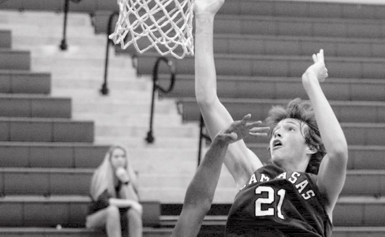 Kaeden Crawford (21) led Lampasas with 40 points over two games on Thursday. He is shown going for a basket against Lometa Hornet Dyllen Workmon. JEFF LOWE | DISPATCH RECORD