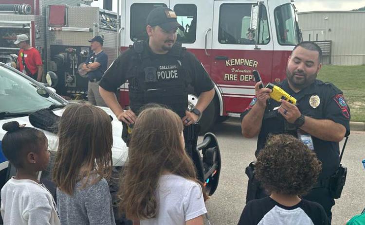 School Resource Officer Carlos Rodriguez, at right, demonstrates some of his law enforcement equipment to interested students. Courtesy photo