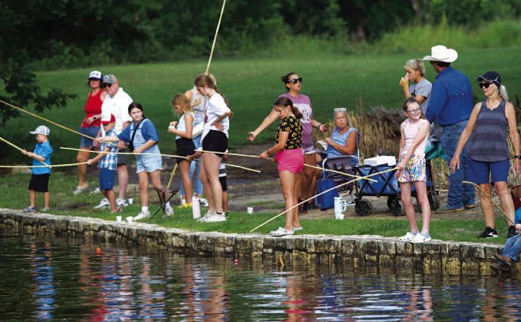 HUNTER KING | DISPATCH RECORD Kids lined the creek in W.M. Brook Park last Wednesday morning for the annual Kiddie Fishing Derby.