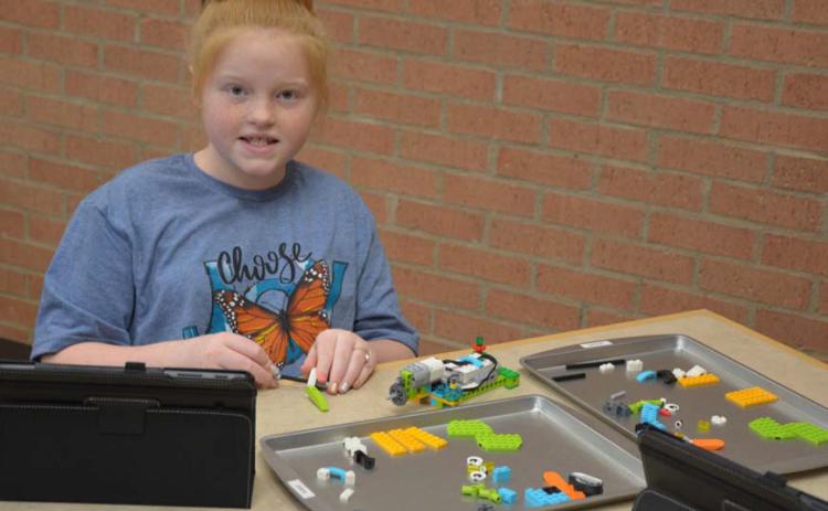 MONIQUE BRAND | DISPATCH RECORD Lauren Martin builds her robot project. Each student has use of a computer tablet with instructions and a controller. The library’s robotics initiative has grown since the program started in 2017. Sessions are offered for homeschool and public school students.