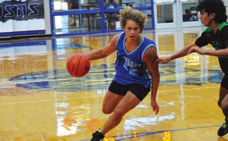 Haegen Oncken drives past a Burnet defender to the basket during Tuesday’s summer league game. HUNTER KING | DISPATCH RECORD