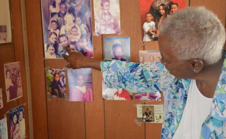 Clementine Walker looks over family photos in her home on Third Street. She retired last month after caring for patients for 56 years at Lampasas Nursing &amp; Rehabilitation. MONIQUE BRAND | DISPATCH RECORD